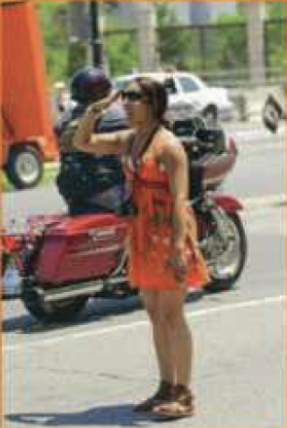 woman saluting riders